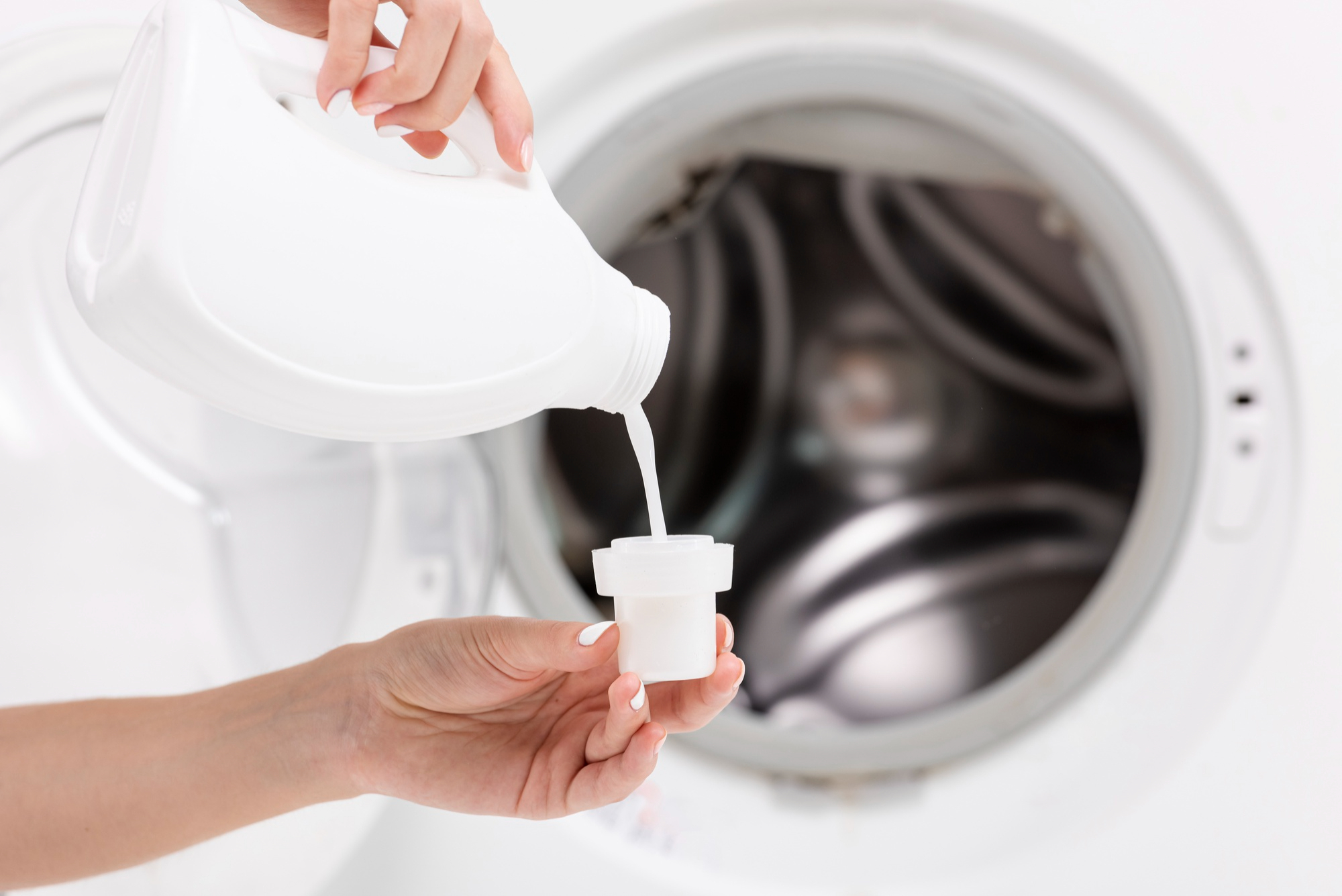 close-up-woman-pouring-detergent-with-washing-machine